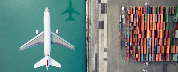 Plane flying over a container yard