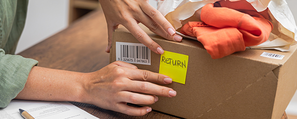 Person marking a box for return